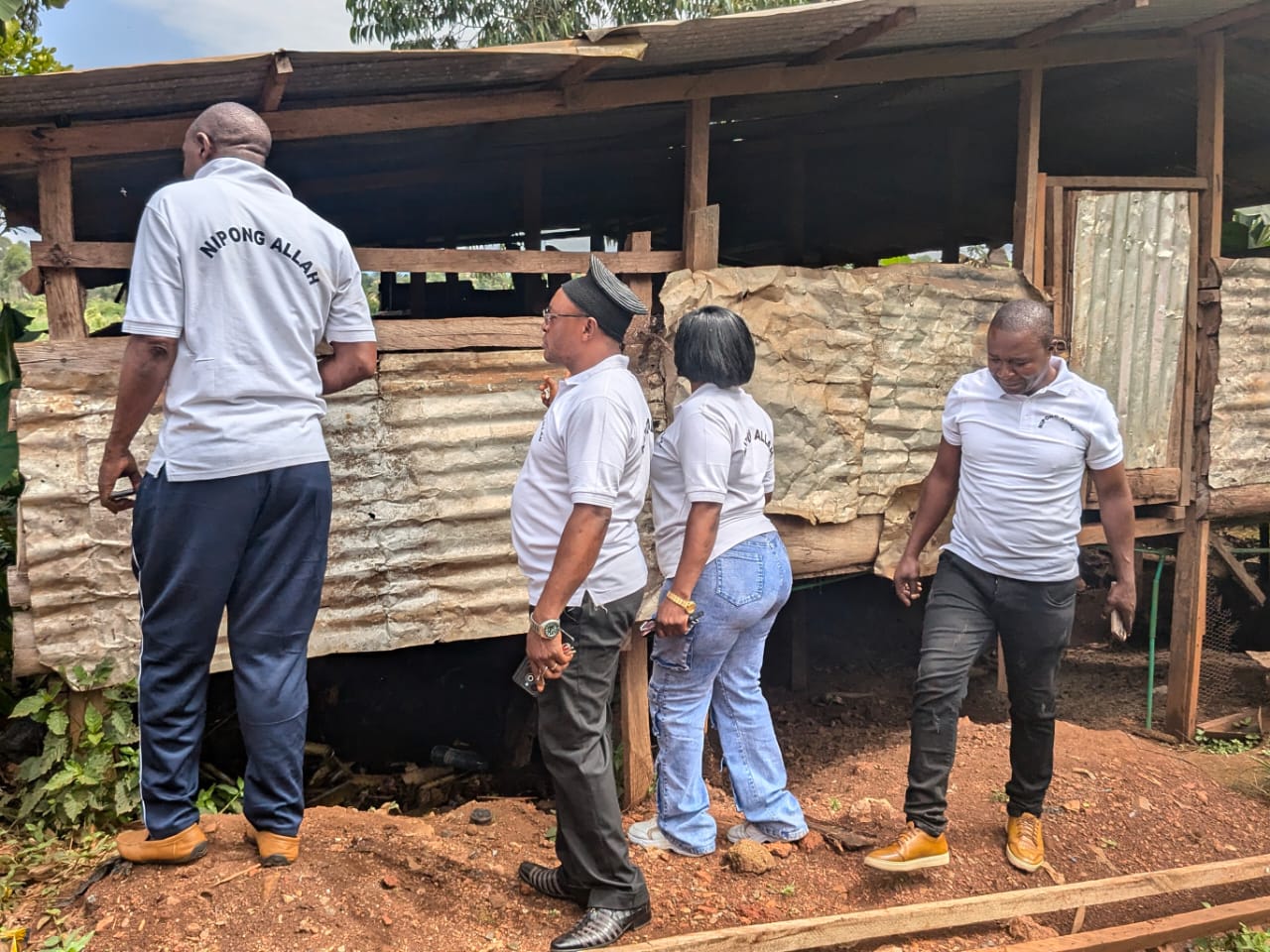 Members inspecting the exterior of the pig farm