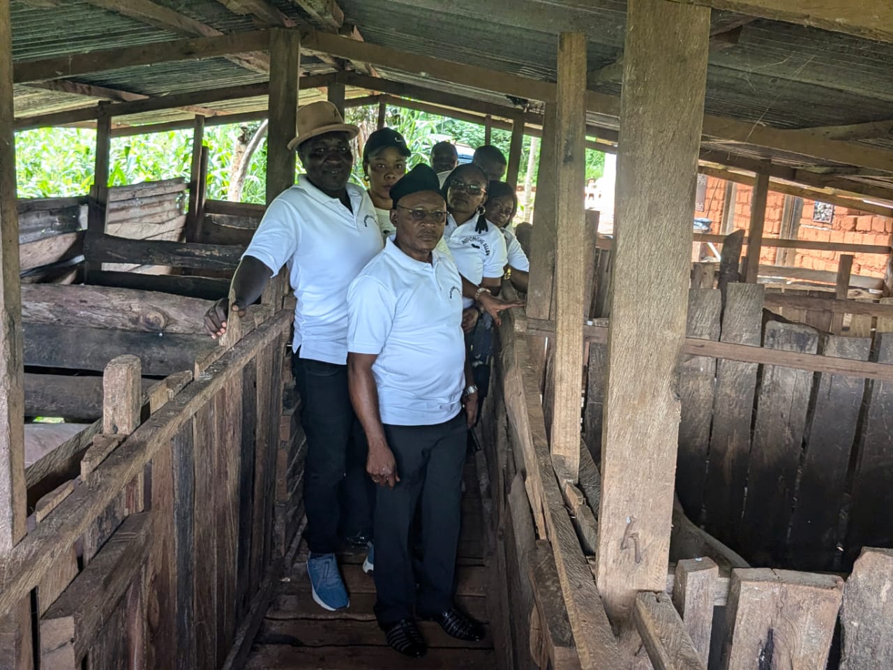 Members gathered inside the pig facility