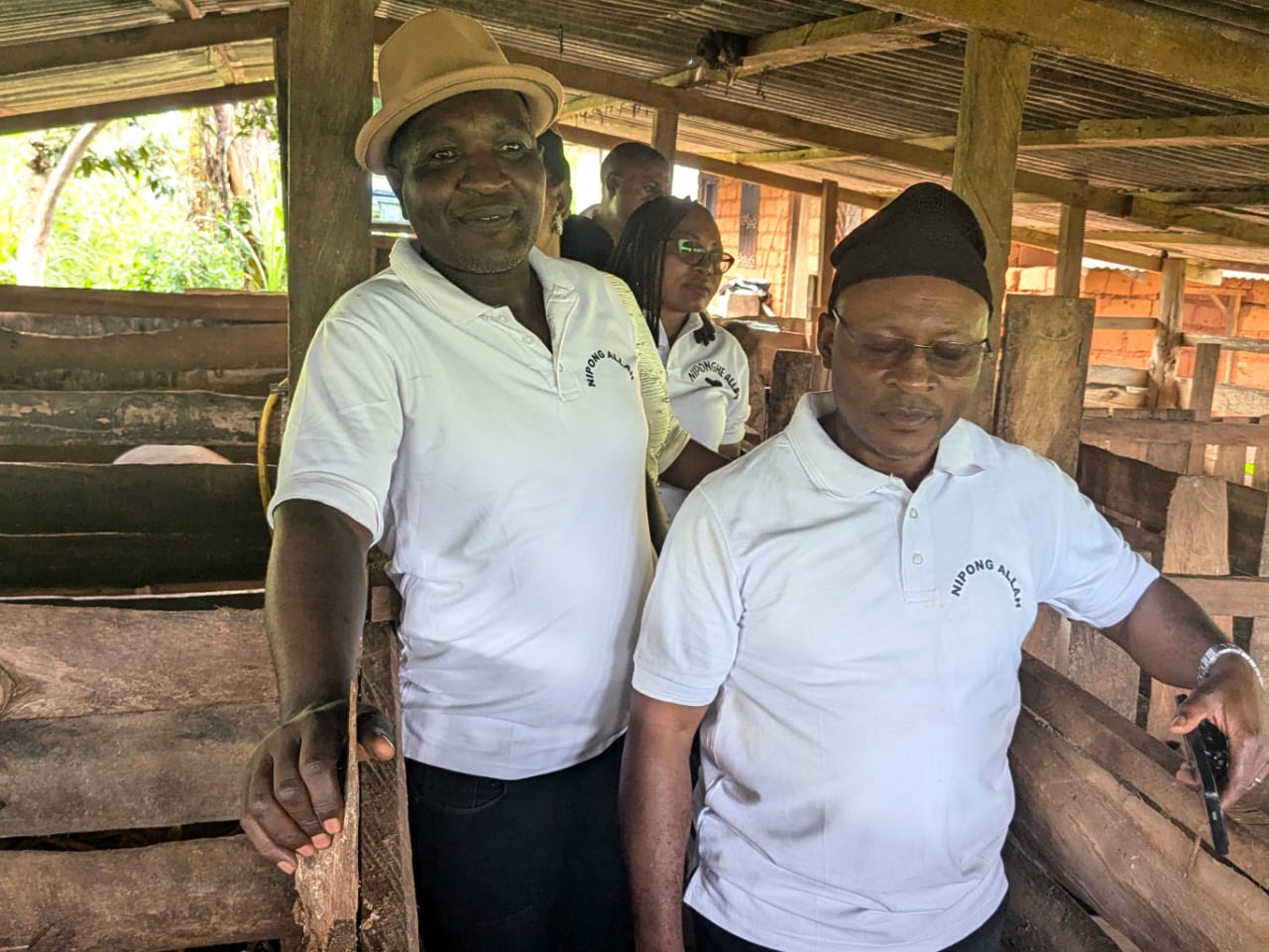 Two members posing in the pig farm